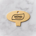 Goldener Kaviardosenöffner – IKRiNKA Öffner flach auf Marmor